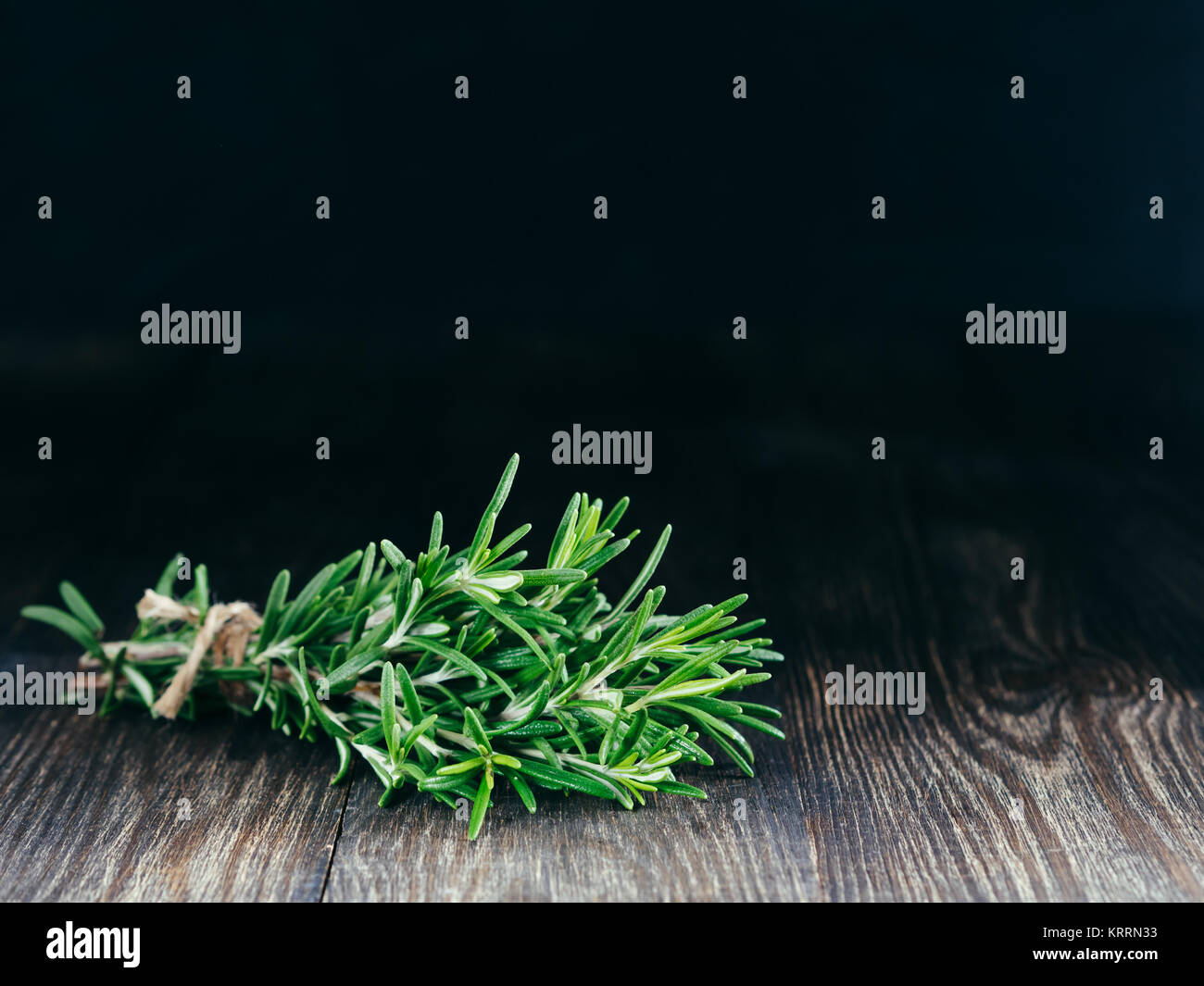 Organic bunch of fresh rosemary on wooden table Stock Photo - Alamy