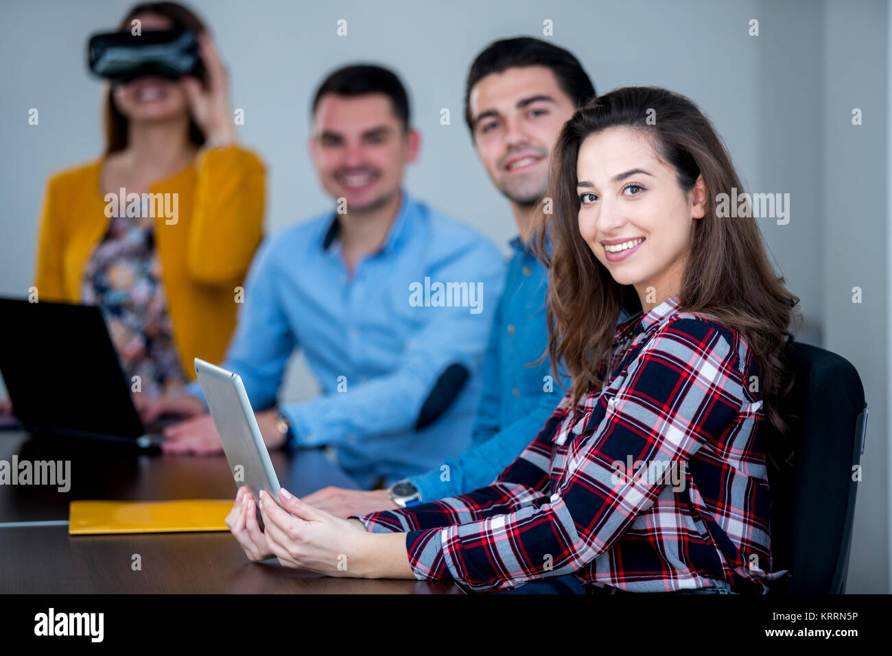 Team of motivated people using various devices at a startup metting ...