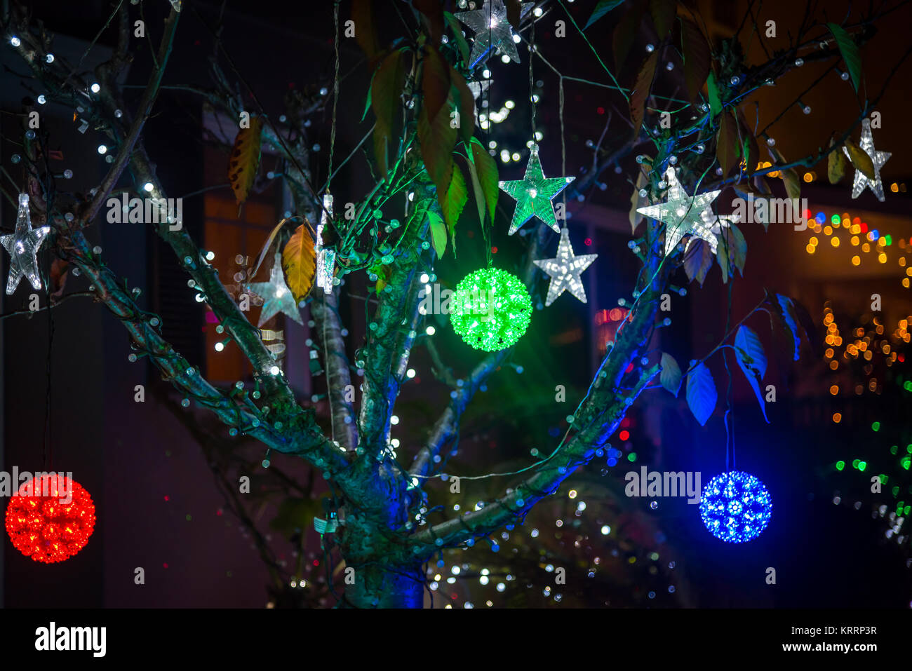 Christmas tree colorful balls and lighting stars Stock Photo - Alamy