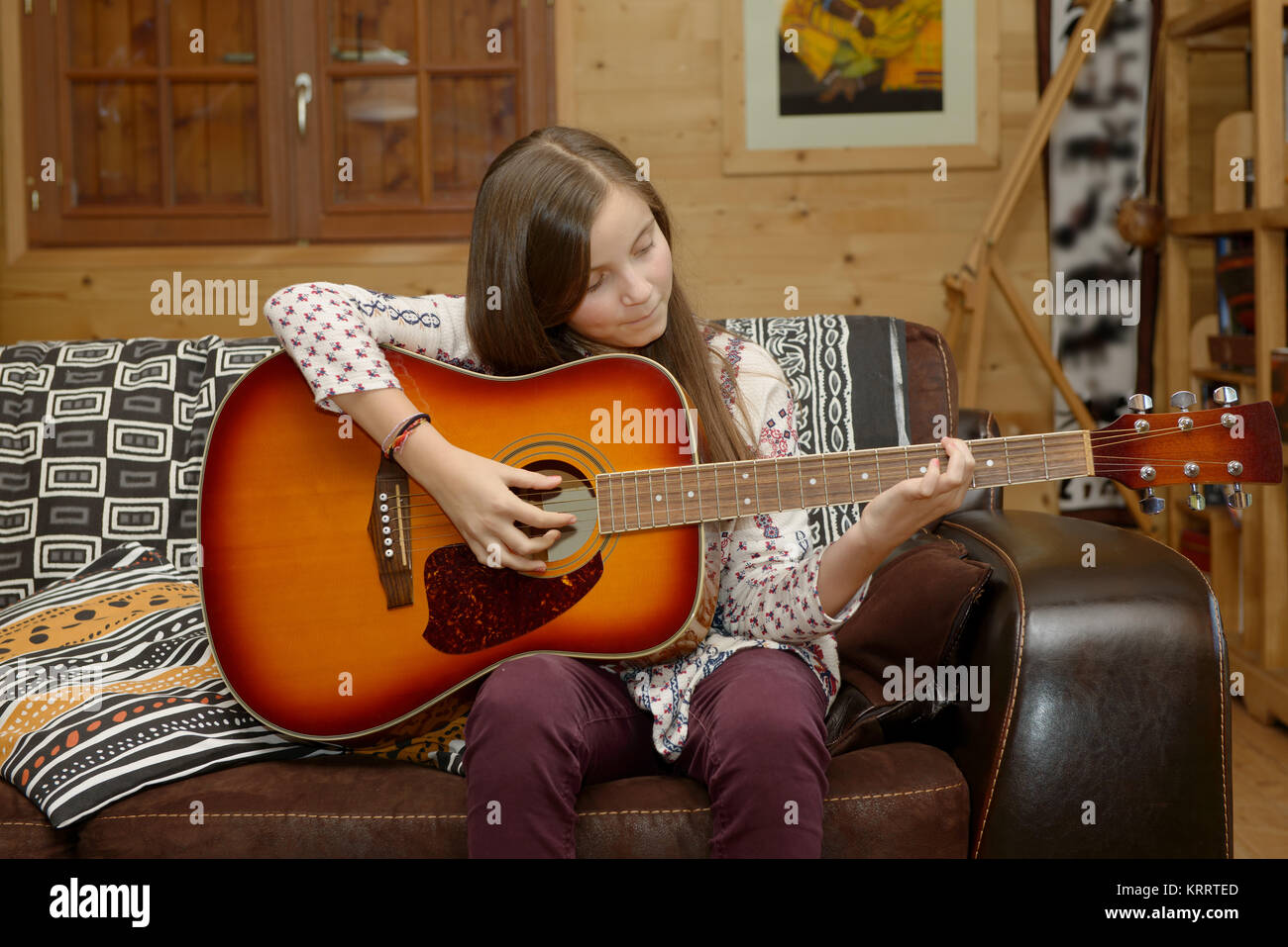 Young teen girl playing acoustic guitar Stock Photo - Alamy