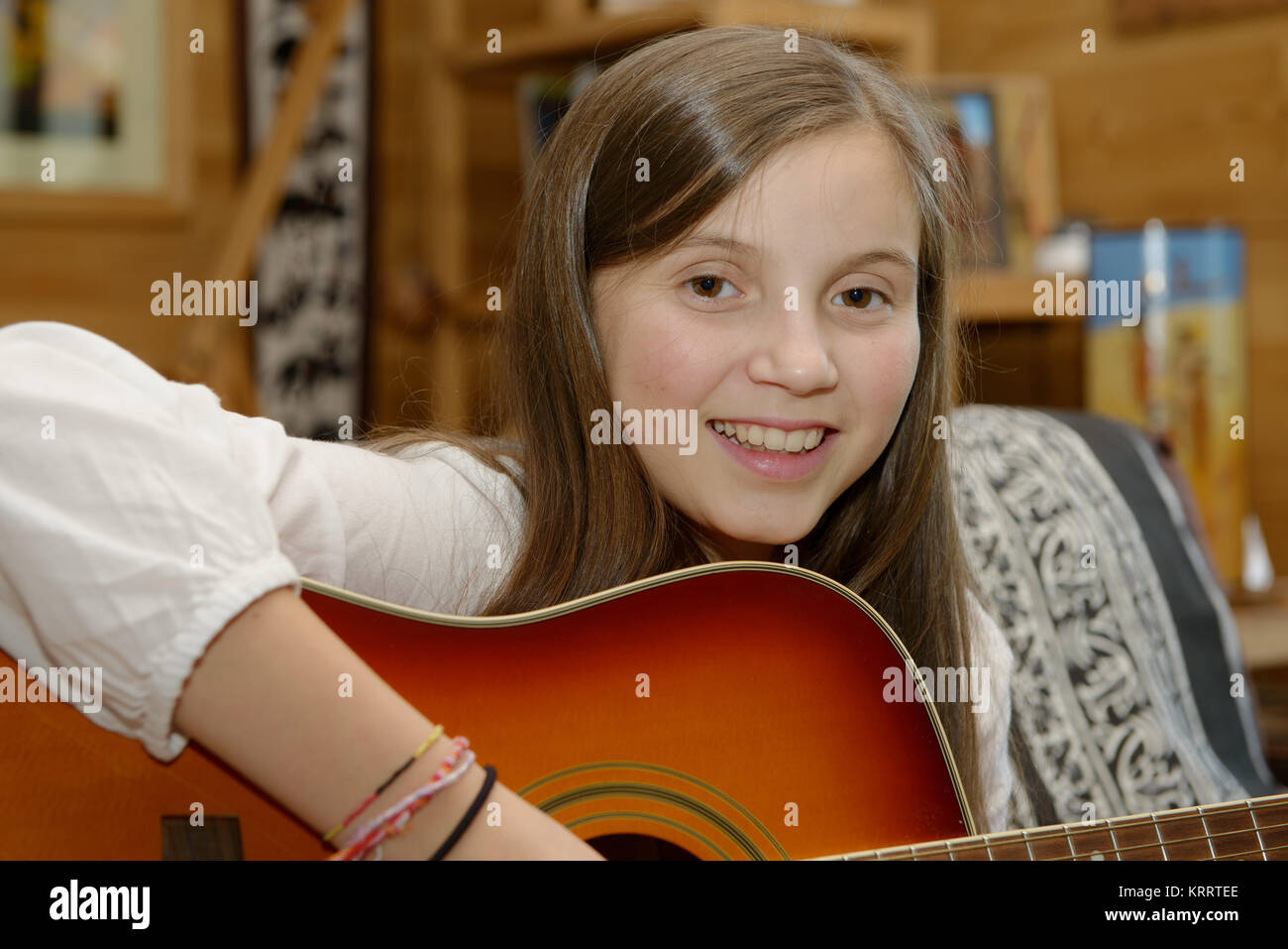 Young teen girl playing acoustic guitar Stock Photo - Alamy