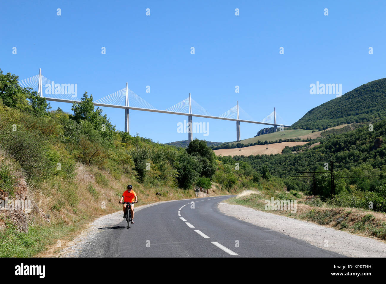 Millau Viaduct, Aveyron, France with cyclist in foreground. The tallest bridge in the world, designed by Norman Foster. Stock Photo