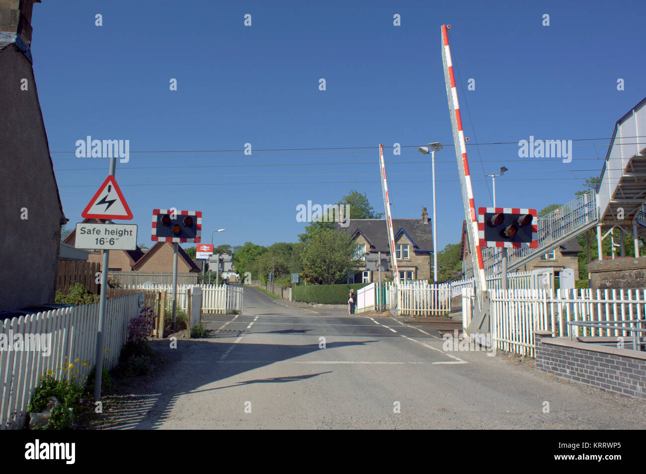 level crossing Cardross Scotland barriers open blue sky sunny day Stock Photo