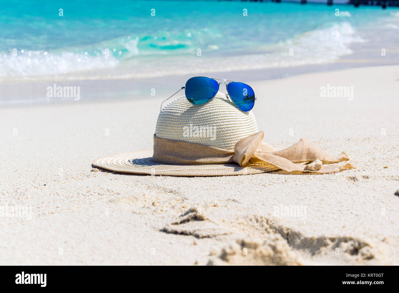 Hat with Sunglasses on the Beach Stock Photo - Alamy