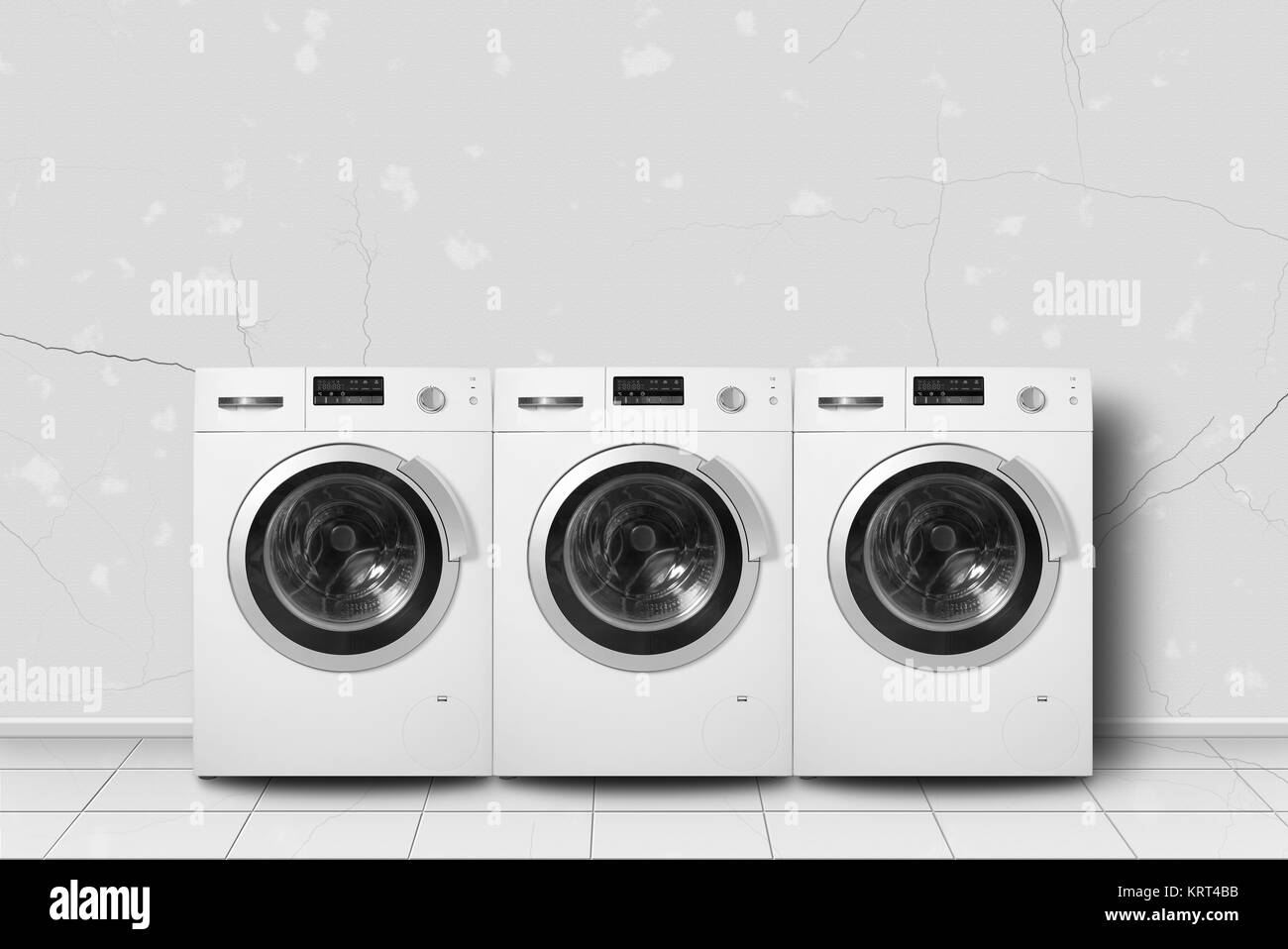 Major appliance - Three washing machine in home interier on a light wall background. Stock Photo
