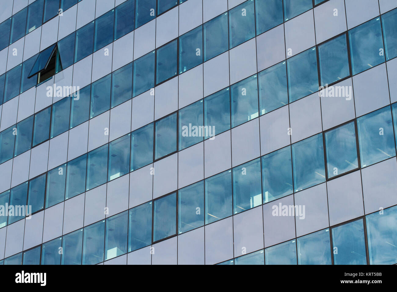 office building with many glass windows and one open Stock Photo - Alamy