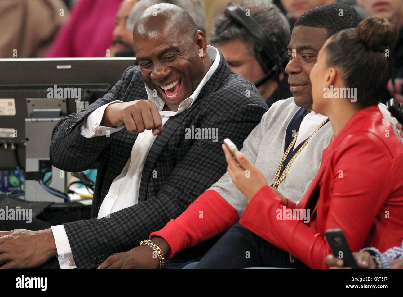 NEW YORK, NY - NOVEMBER 08: (Embargoed till November 10, 2015) Magic Johnson, Tracy Morgan with wife Megan Wollover sit with Michael K. Williams and  Director Spike Lee at the New York Knicks vs Los Angeles Lakers game at Madison Square Garden on November 8, 2015 in New York City.   People:  Magic Johnson, Tracy Morgan, Megan Wollover Stock Photo