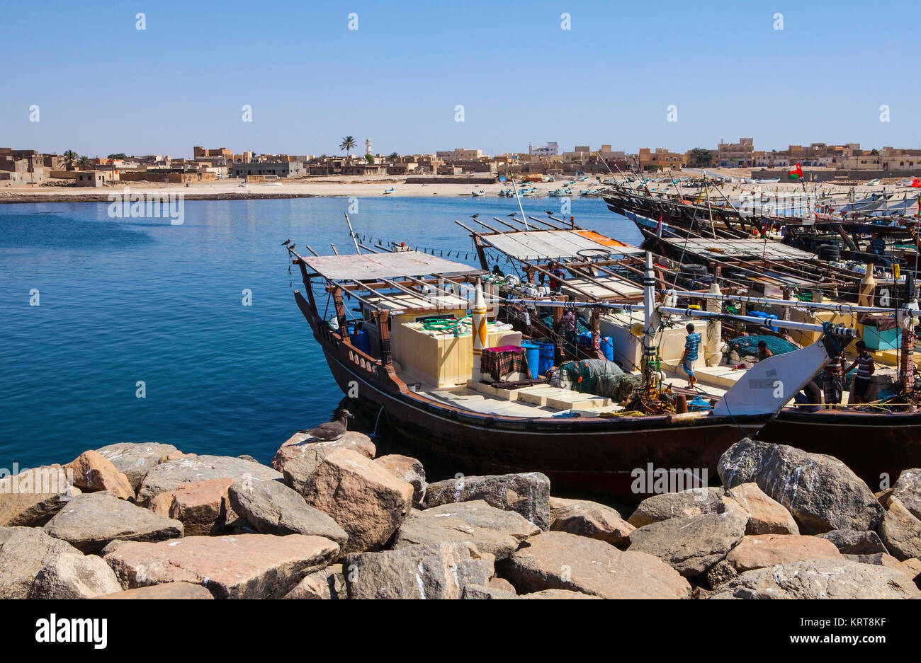 MIRBAT, OMAN - JANUARY 07,2016: Fishing boats (Dhow) in Mirbat port. Dhofar, Oman. Stock Photo