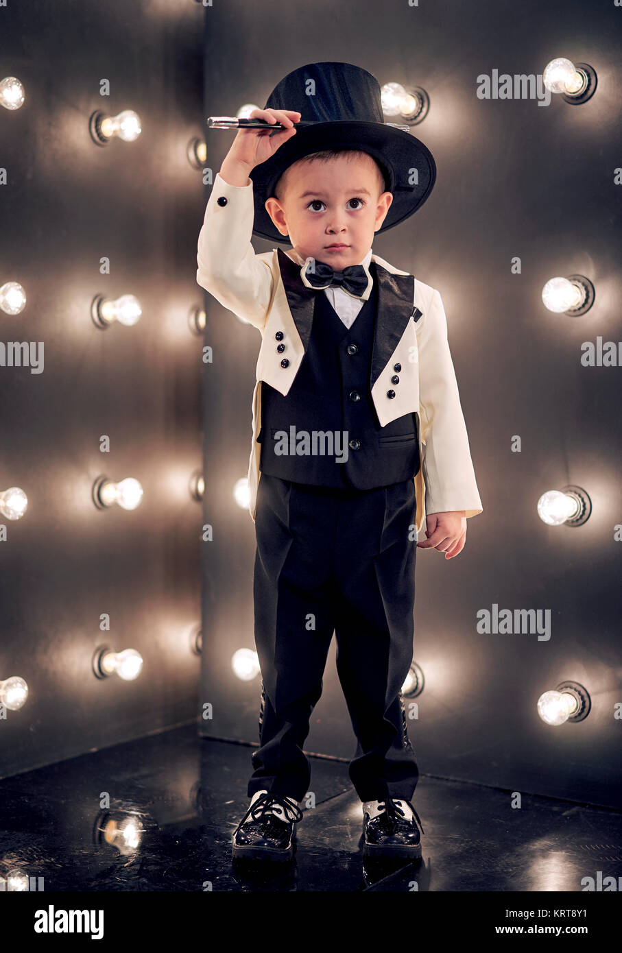 child magician with magic wand and hat Stock Photo