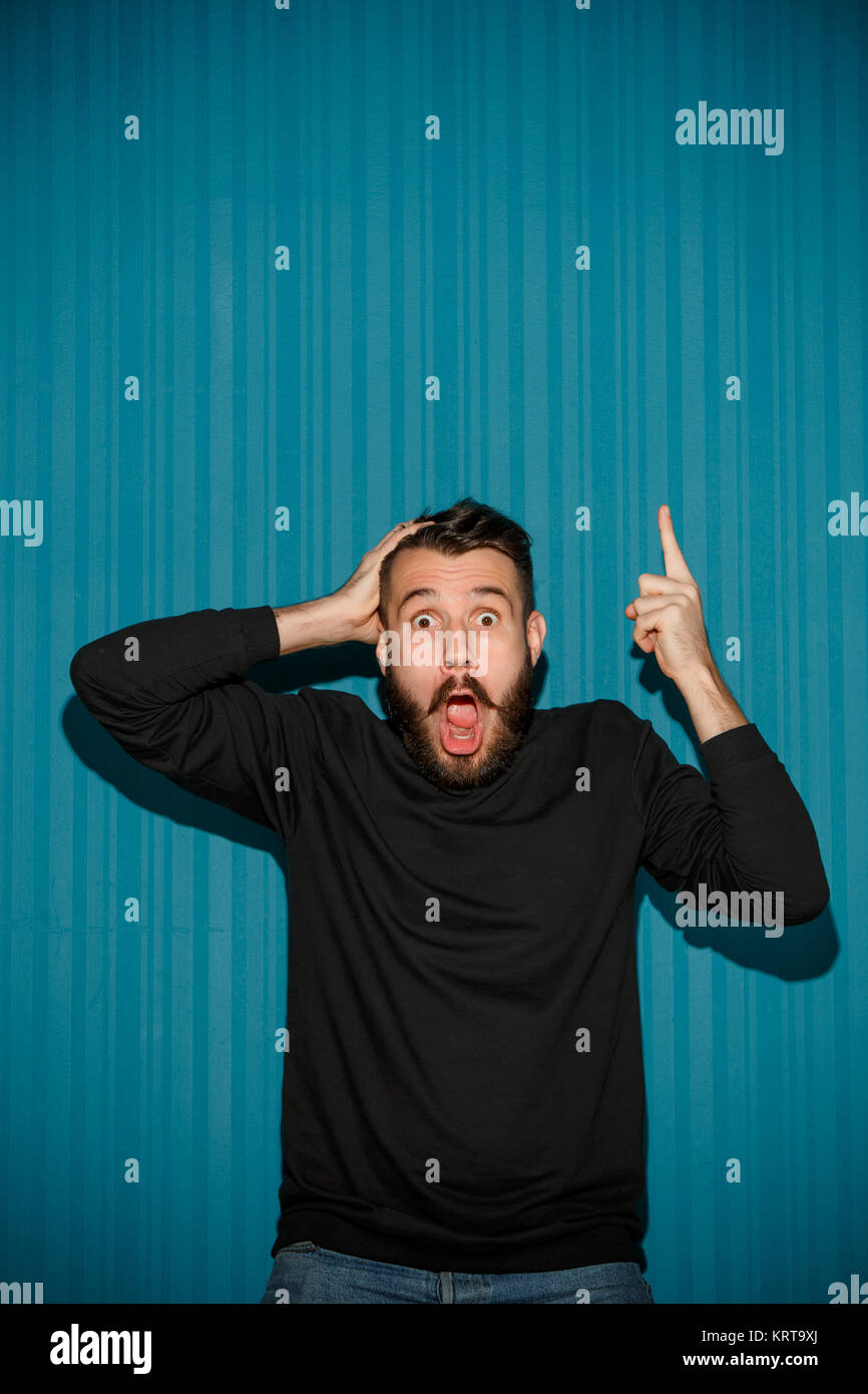 Portrait of young man with shocked facial expression Stock Photo - Alamy