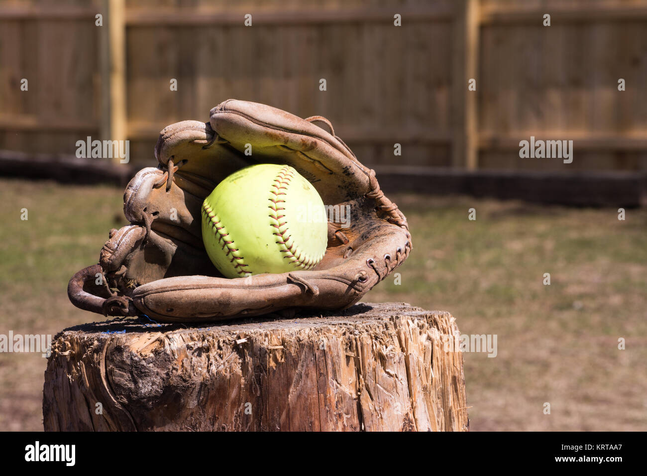 yellow softball in a catching glove up close Stock Photo Alamy
