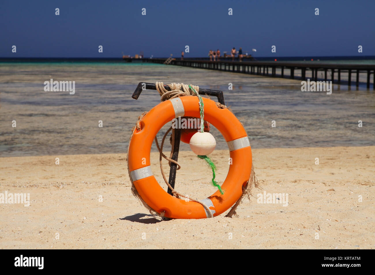Lifebuoy on sandy beach, near coral reef. Marsa Alam, Egypt Stock Photo