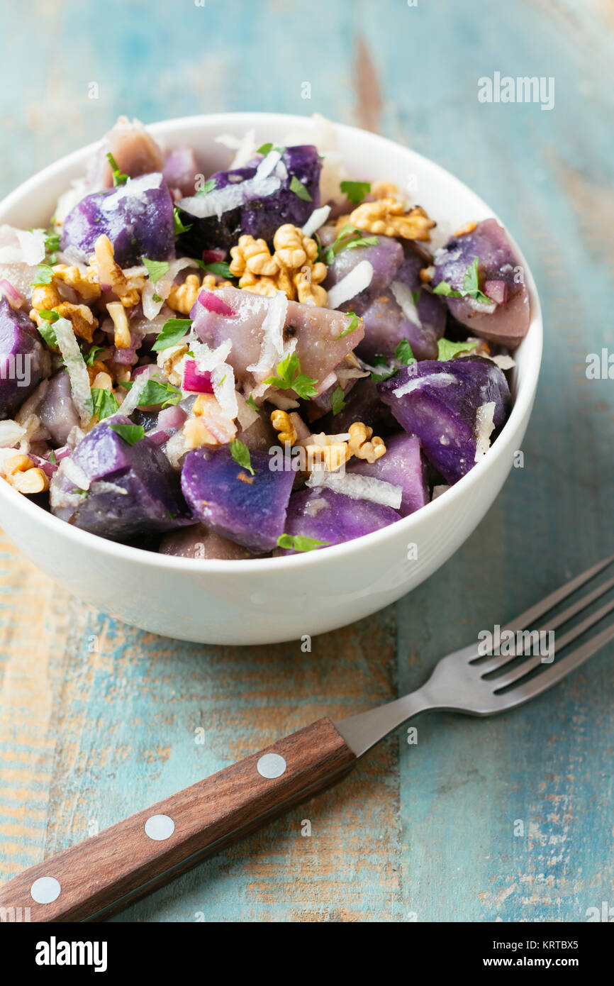 Purple Potato Salad with Grated Radish and Walnuts Stock Photo