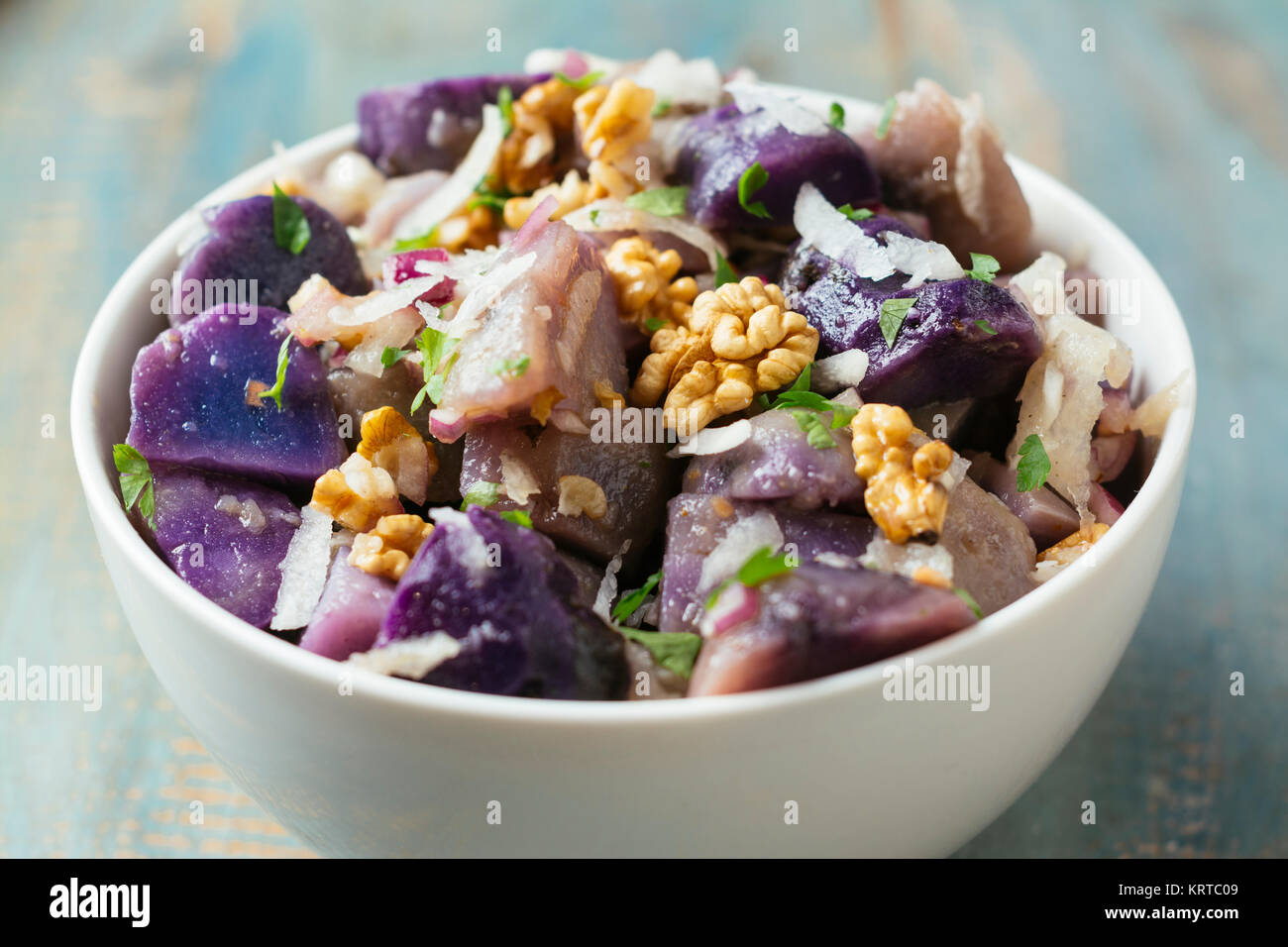 Purple Potato Salad with Grated Radish and Walnuts Stock Photo