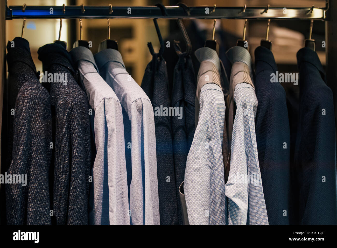 Men clothing on hangers in a fancy shoip Stock Photo Alamy
