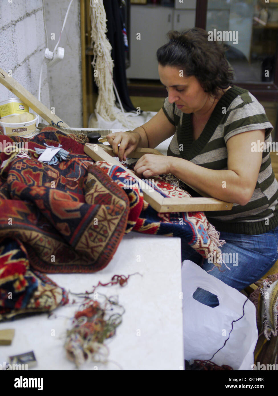Armenian woman weaving a carpet, Yerevan, Armenia, October 2012 An