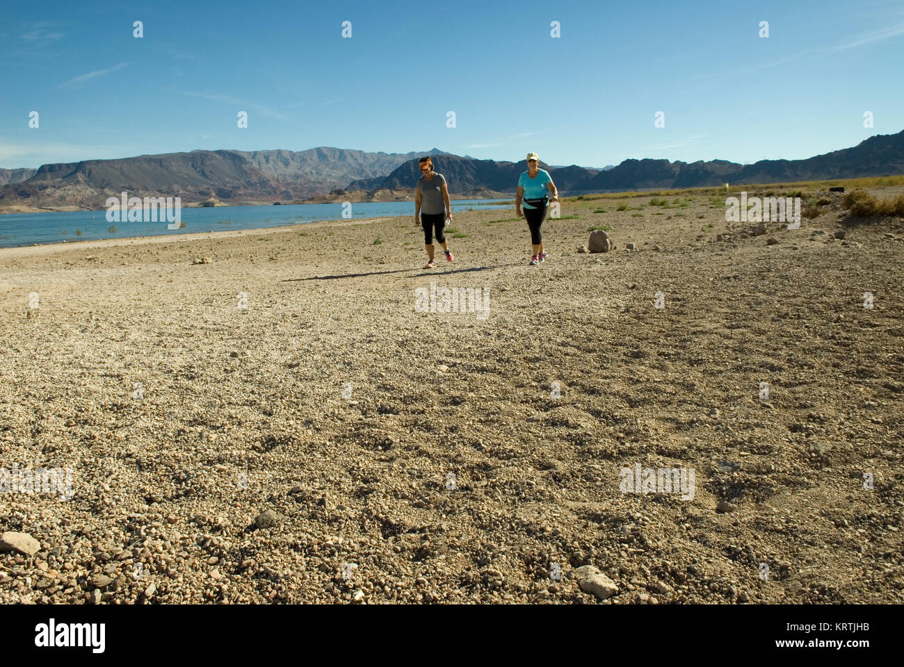 Caucasian Females take a stroll along  beach area at Lake Mead National Recreation Area Nevada, USA. Stock Photo