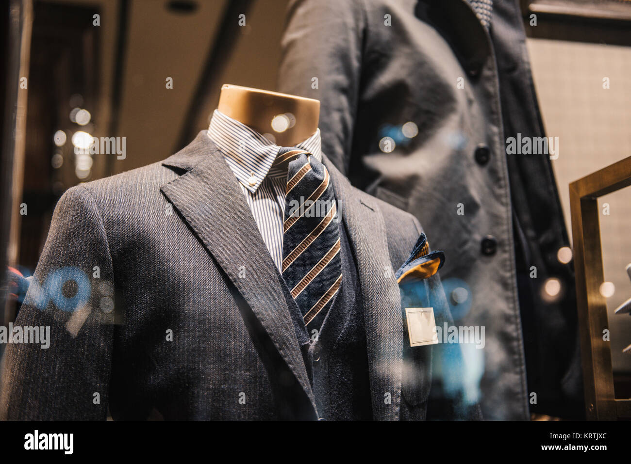 Detail of a clothing mannequin in a men suit shop with a white brick wall  on the background. Elegance concept. Square format Stock Photo - Alamy