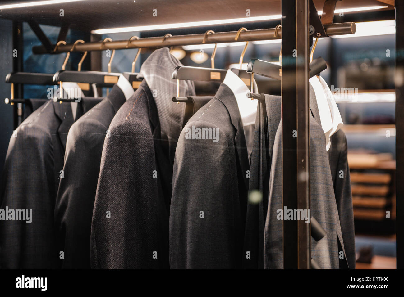 Men suits on hangers Stock Photo - Alamy
