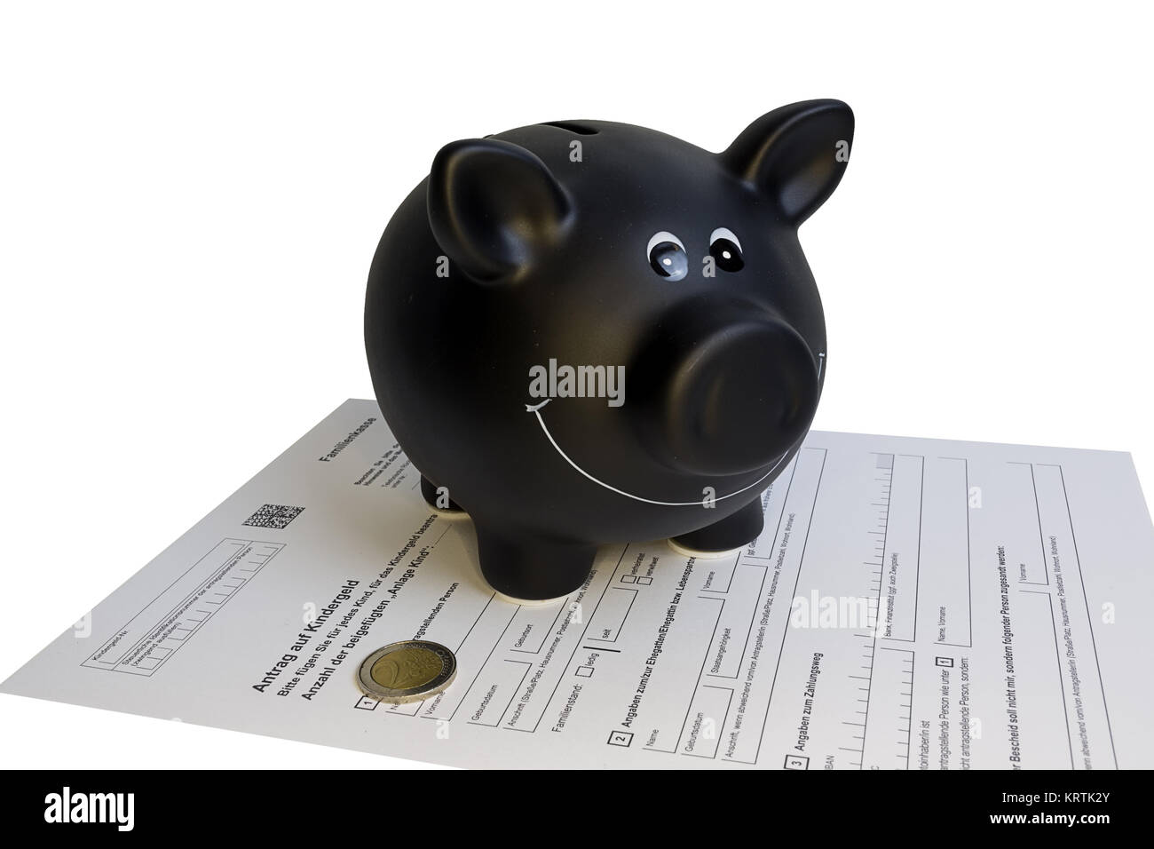 black piggy bank standing on child support application with two euro coin Stock Photo