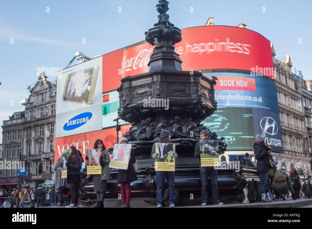 Vegans hold posters showing animals and saying they can think and feel and want to stay alive around the base of Eros at Piccadilly Circus Stock Photo