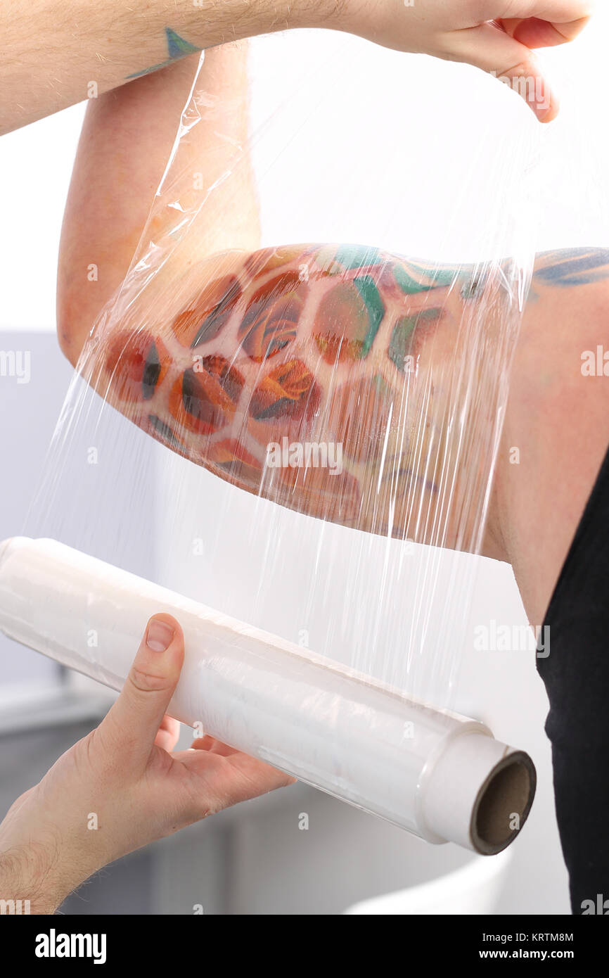 securing tattoo stretch film Stock Photo Alamy