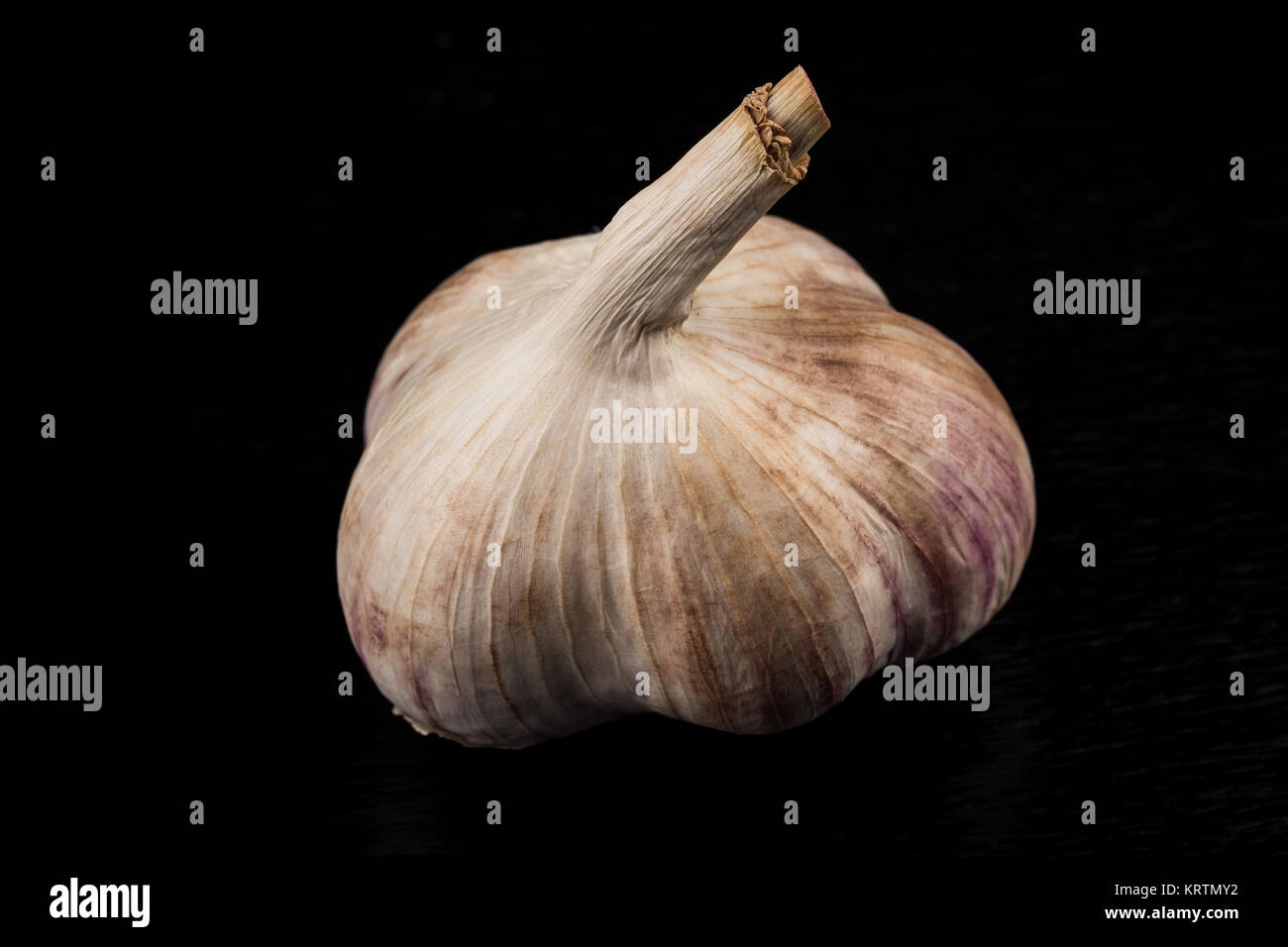 Garlic bulb on dark background Stock Photo - Alamy
