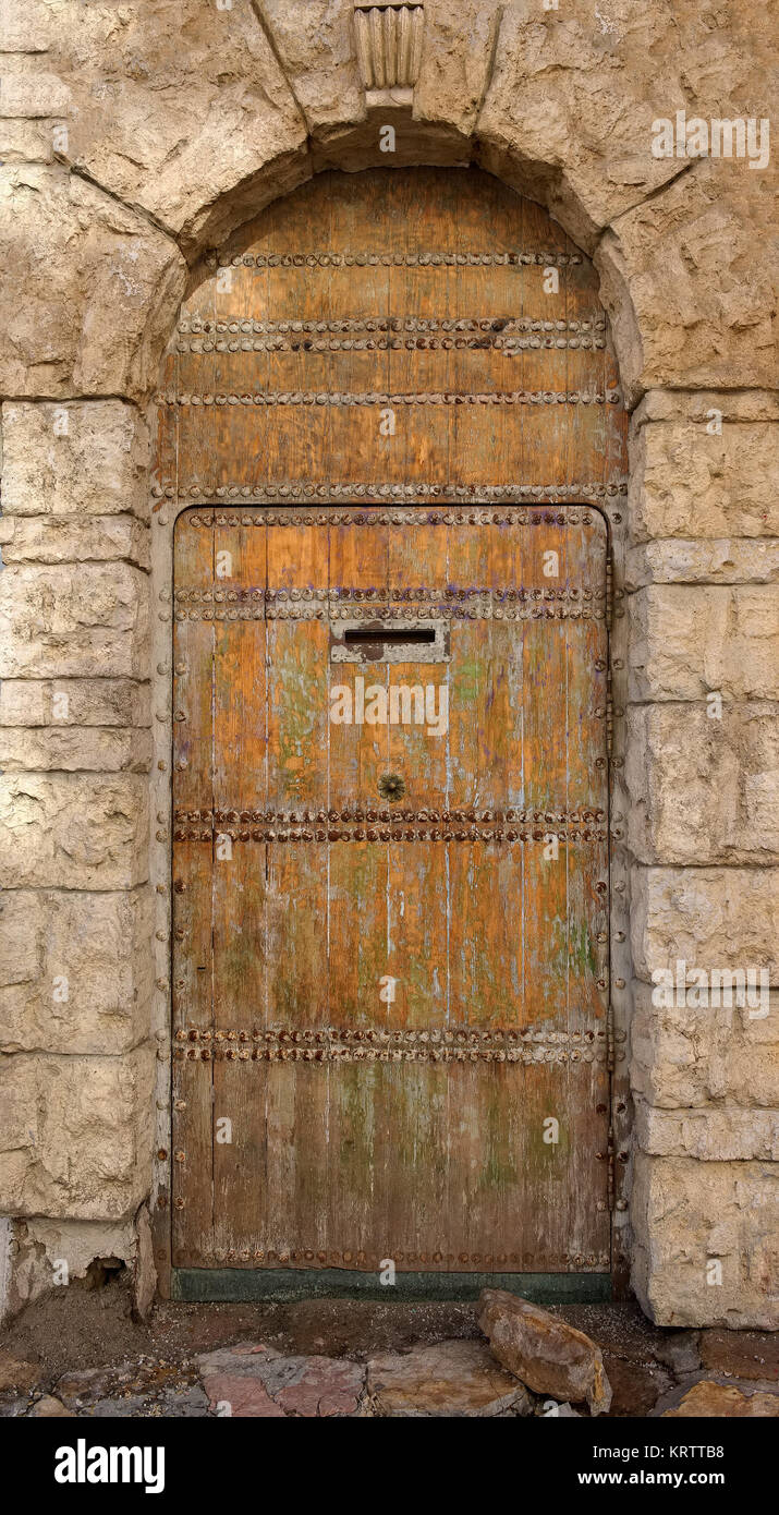 Old wooden door in the stone wall Stock Photo - Alamy