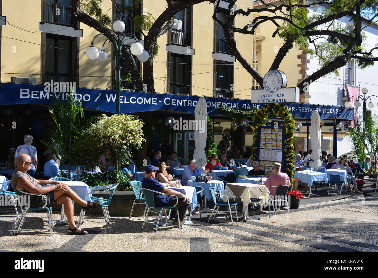 People seated at outdoor tables of the  Restaurante Centro Comercial da Sé, Funchal, Madeira, Portugal Stock Photo