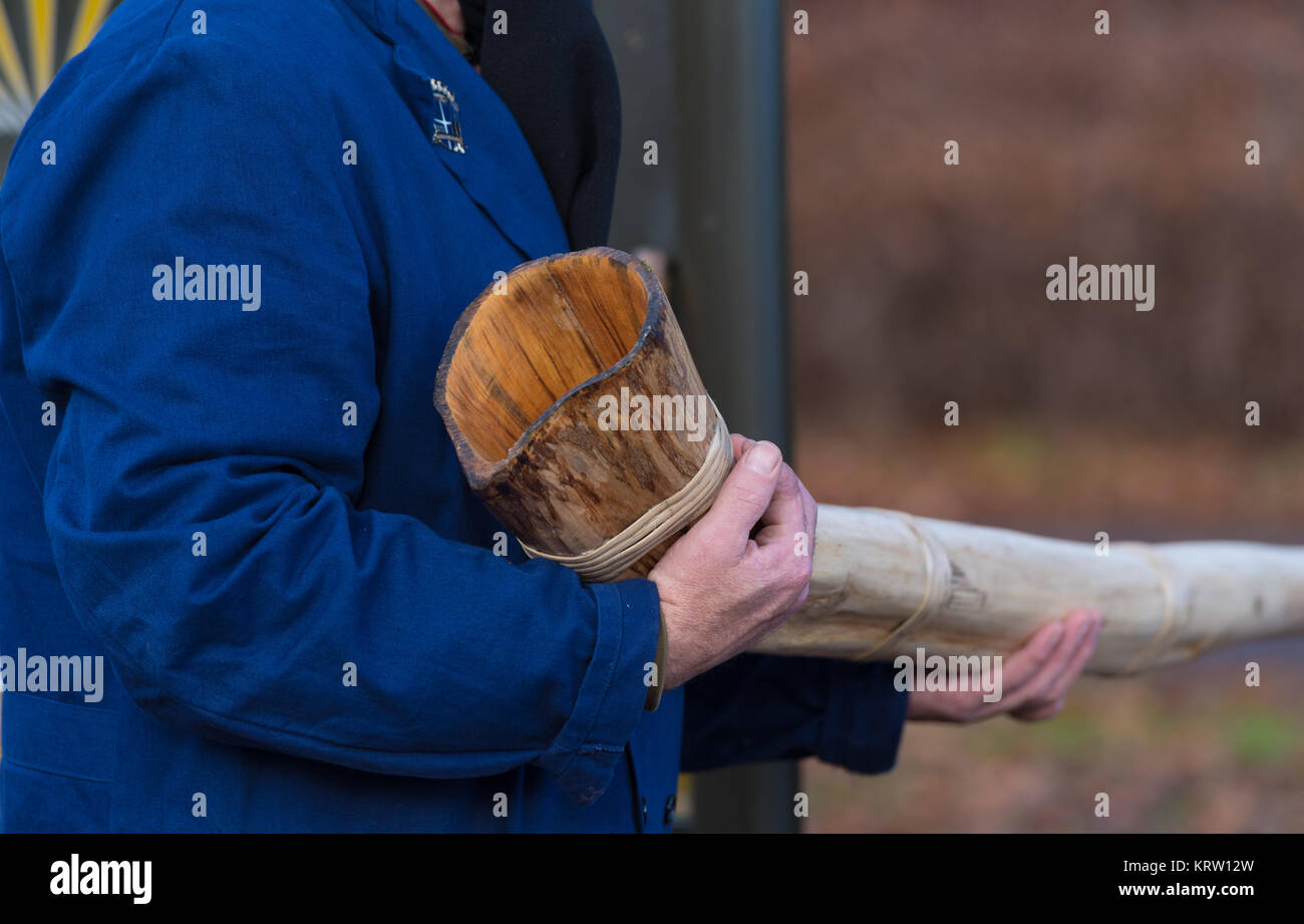 man holding wooden horn Stock Photo