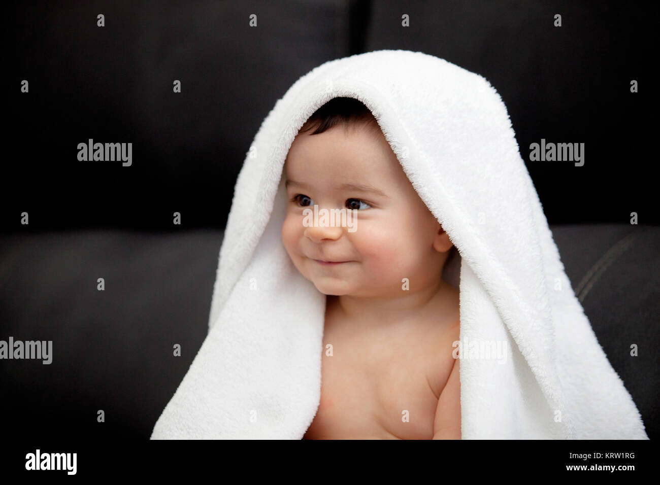 Adorable baby covered with a towel Stock Photo Alamy