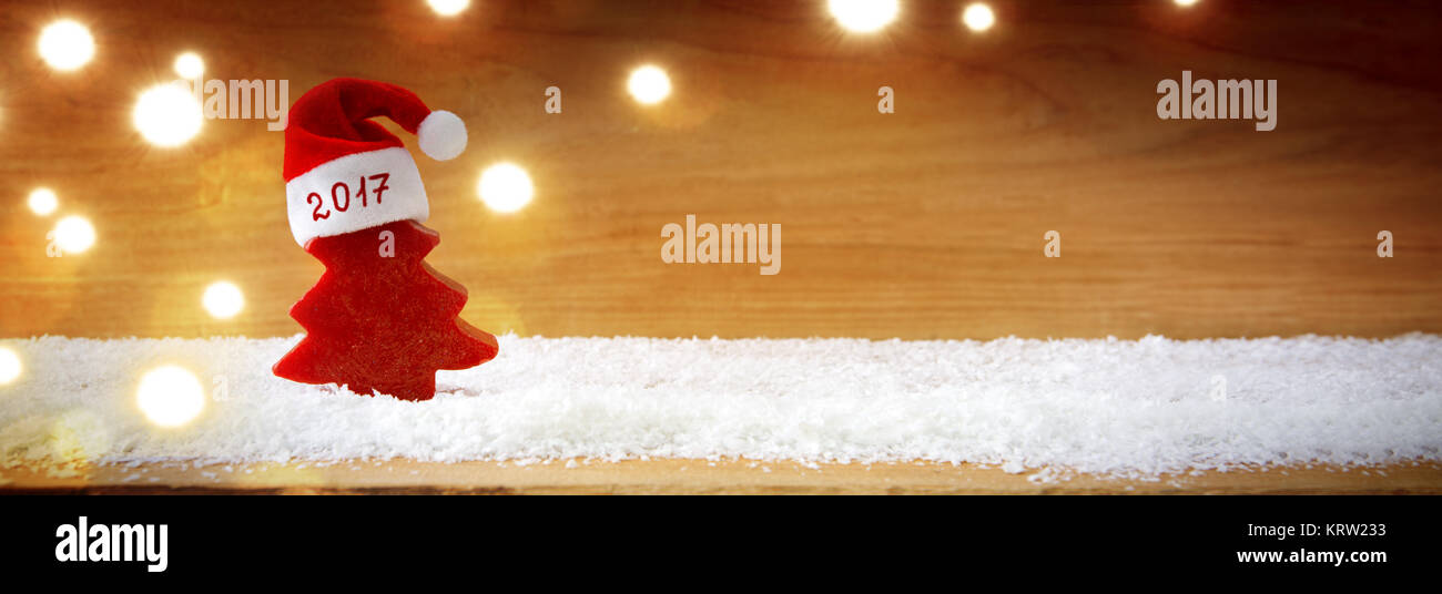 Christmas background with red hat , fir tree and lights. Snow