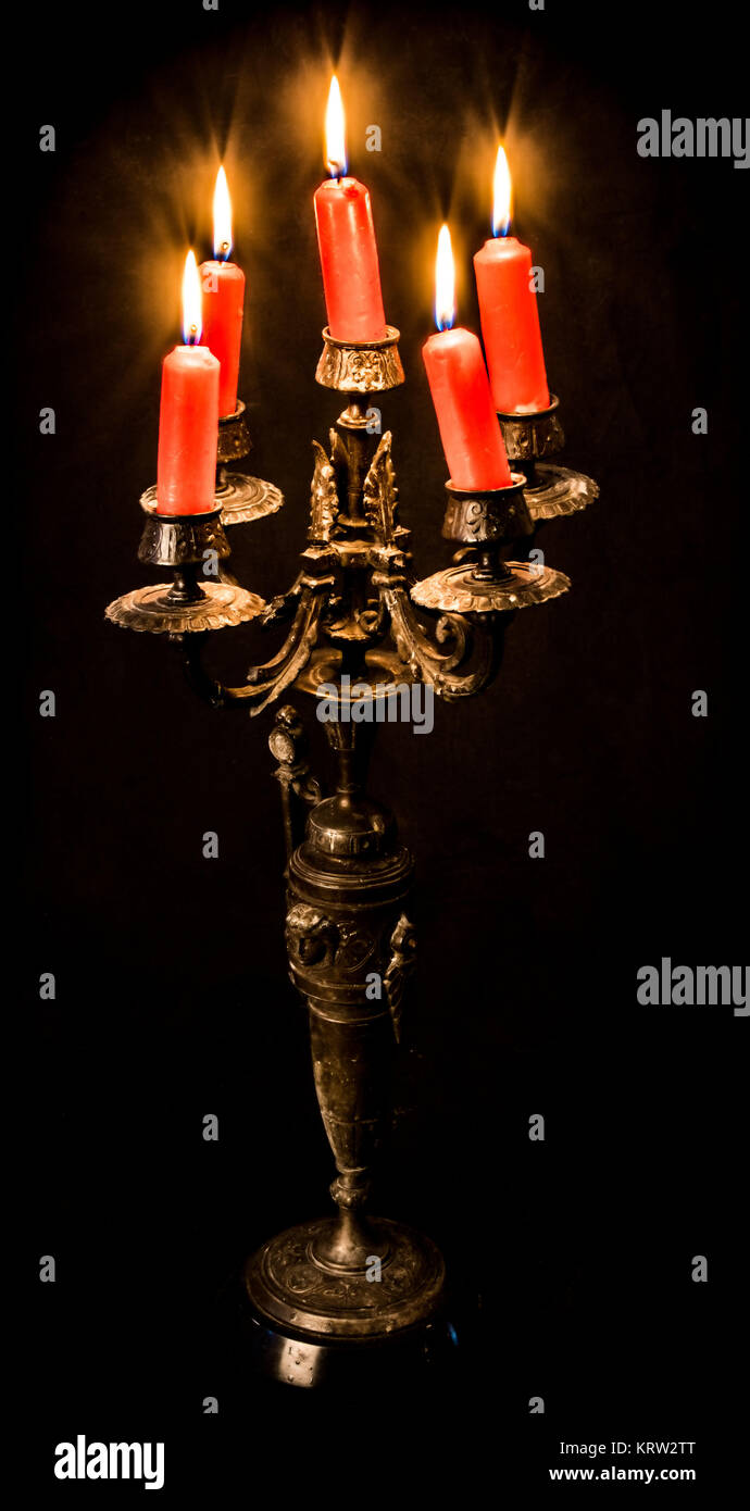 age candlesticks with 5 burning candles Stock Photo