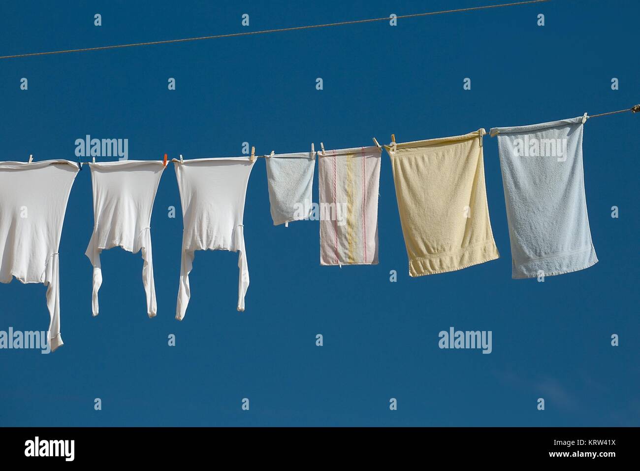 Clothes line of washed clothes hung to dry hi-res stock photography and ...
