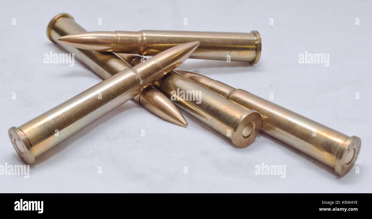 Several large caliber rifle bullets together on a white background Stock Photo