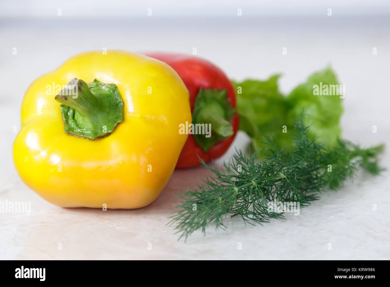 On the table lay a large ripe fruit of the pepper red, yellow and green. Stock Photo