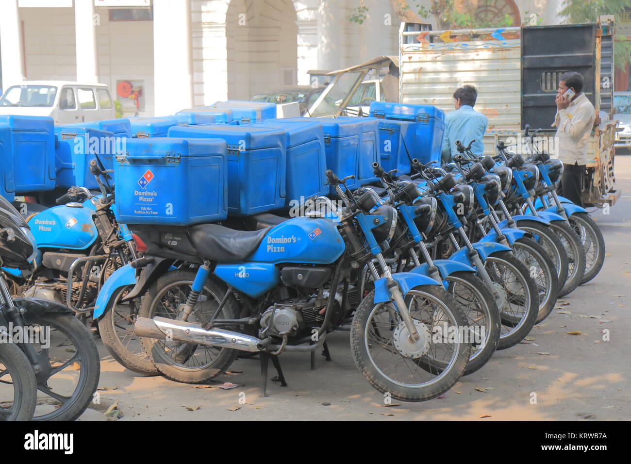 Dominos pizza fast food delivery bikes parked in downtown New Delhi India Stock Photo
