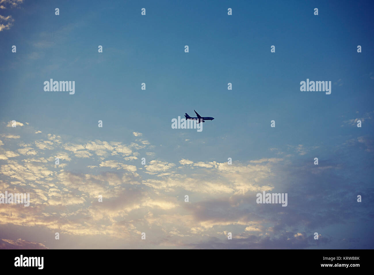 Passenger airplane in blue sky Stock Photo - Alamy