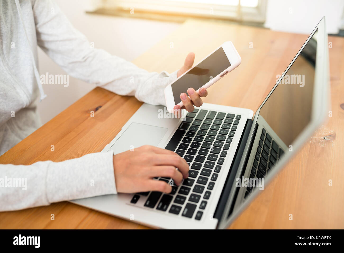 Use computer and mobile phone Stock Photo - Alamy