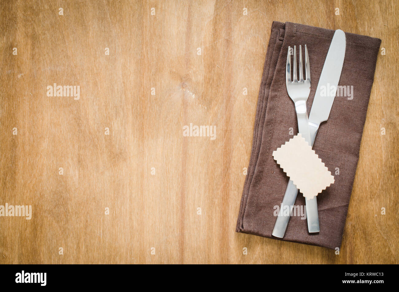 Table Setting. Silverware with Empty Tag on Linen Napkin Stock Photo