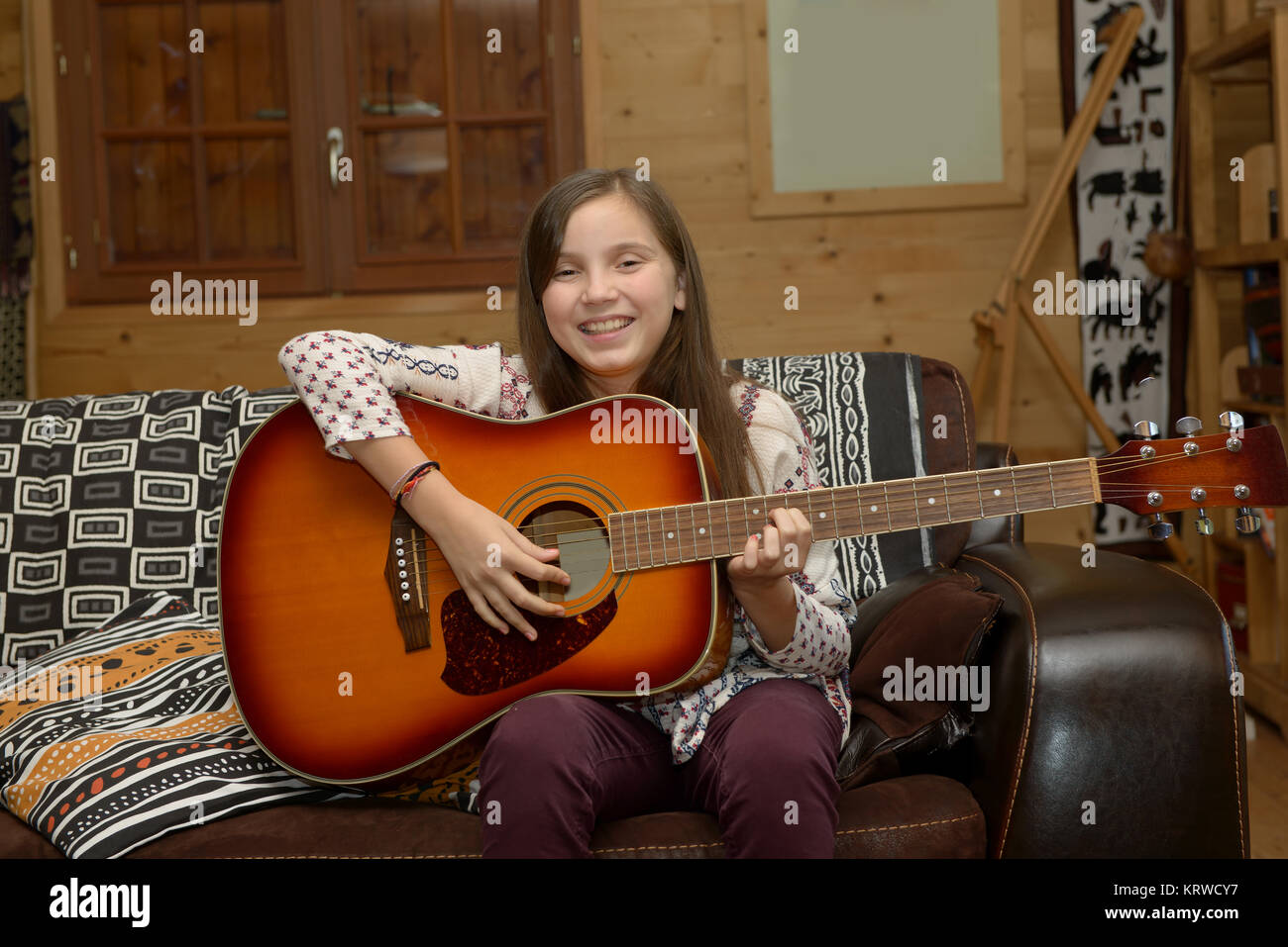 Young teen girl playing acoustic guitar Stock Photo - Alamy