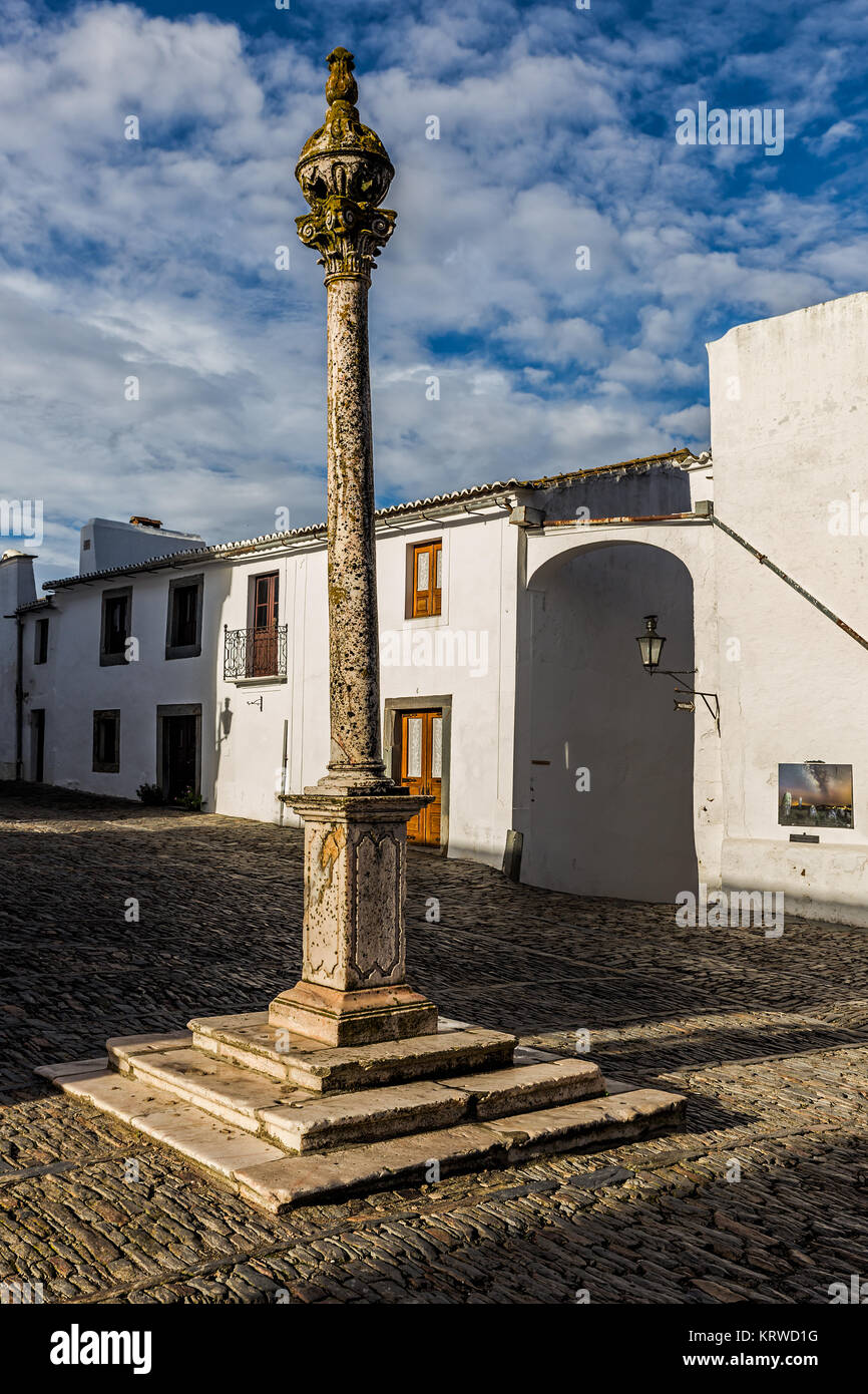 Pillory of Monsaraz (Portugal) is the sixteenth century, made of white marble of Estremoz. In classical style is surmounted by a globe. Stock Photo