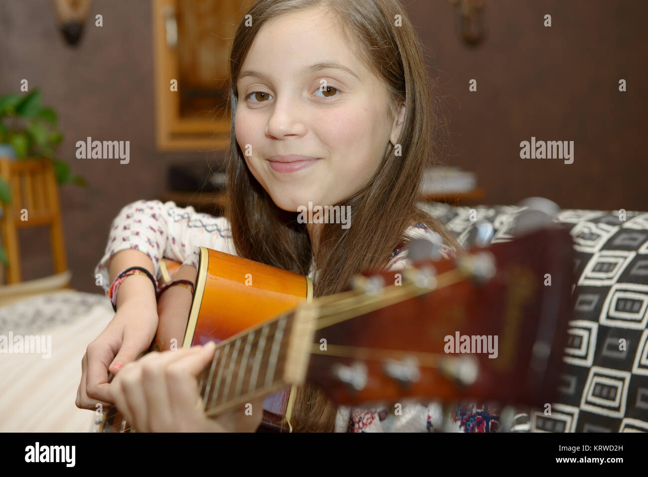 Young teen girl playing acoustic guitar Stock Photo - Alamy