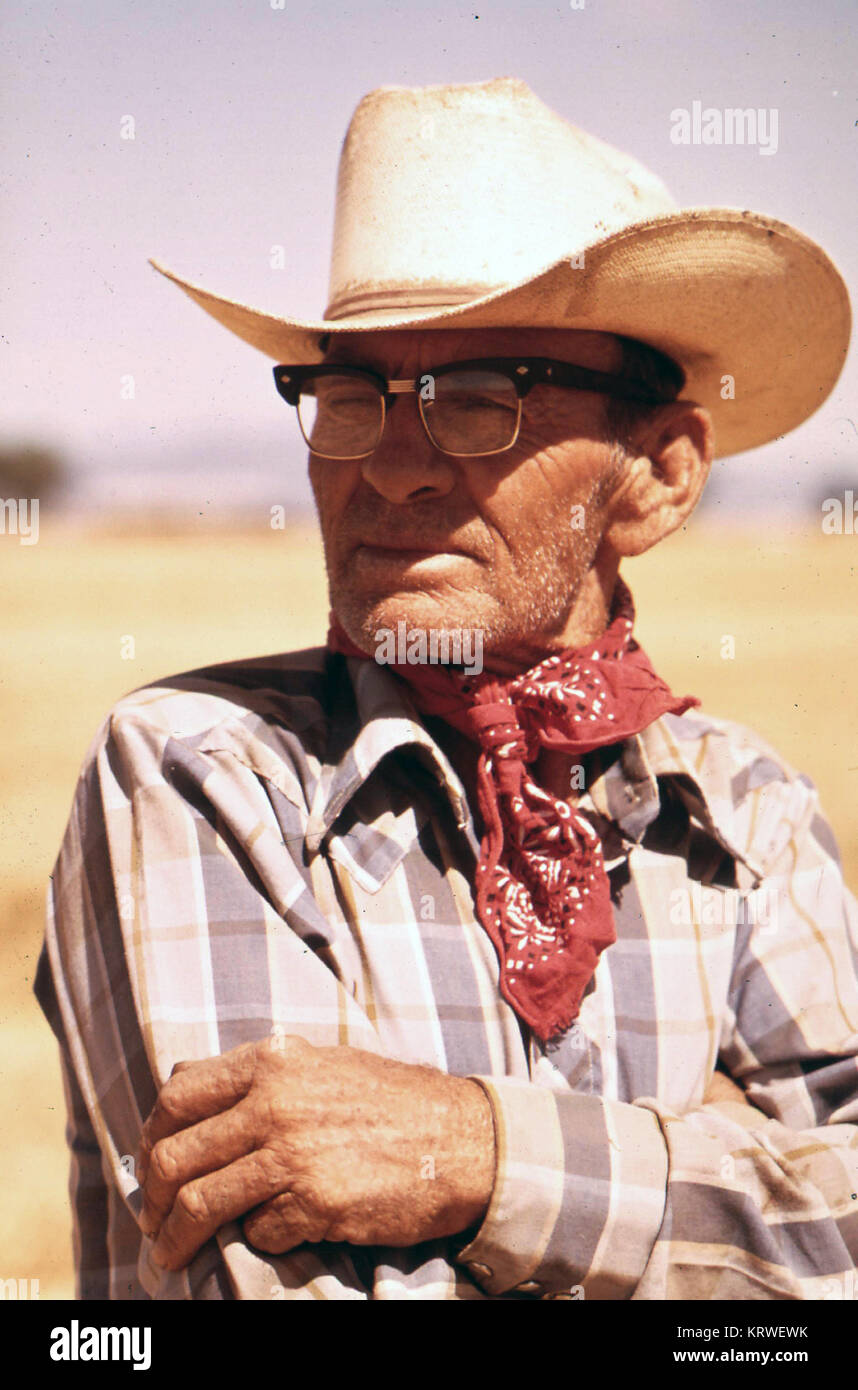 Old Cowboy looking over his ranch in the early 1970s Stock Photo