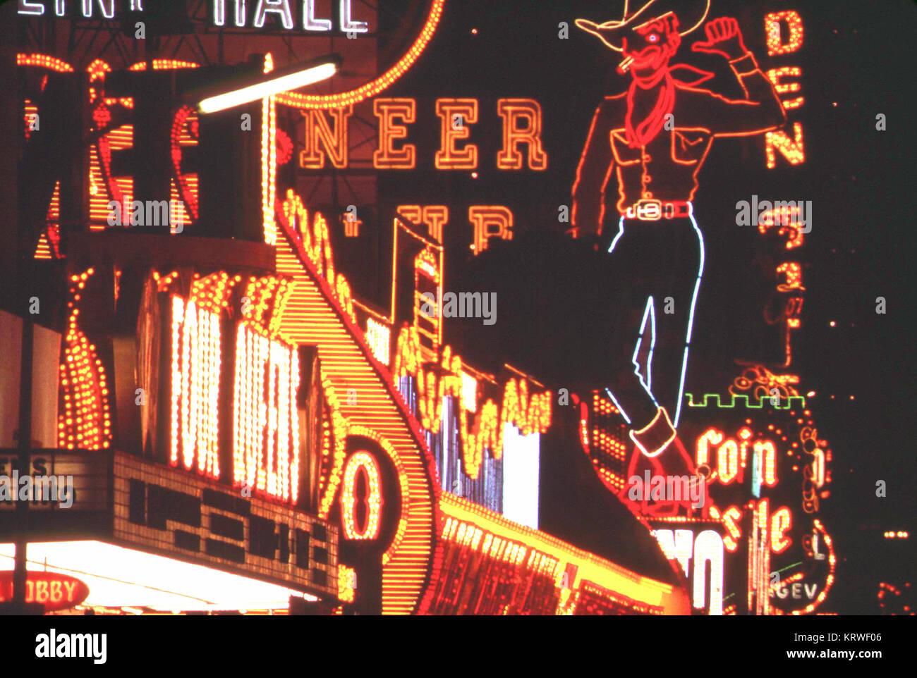Lots of neon lights on an early 1970s evening in Las Vegas, Nevada (Old neon cowboy sign) Stock Photo