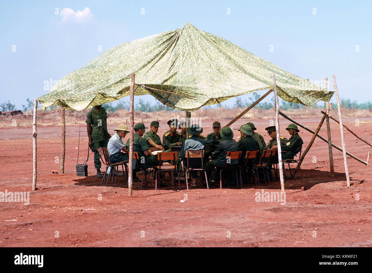 Delegates of the International Control Commission hold a meeting prior to the release of prisoners of war nearing the end of the conflict Stock Photo