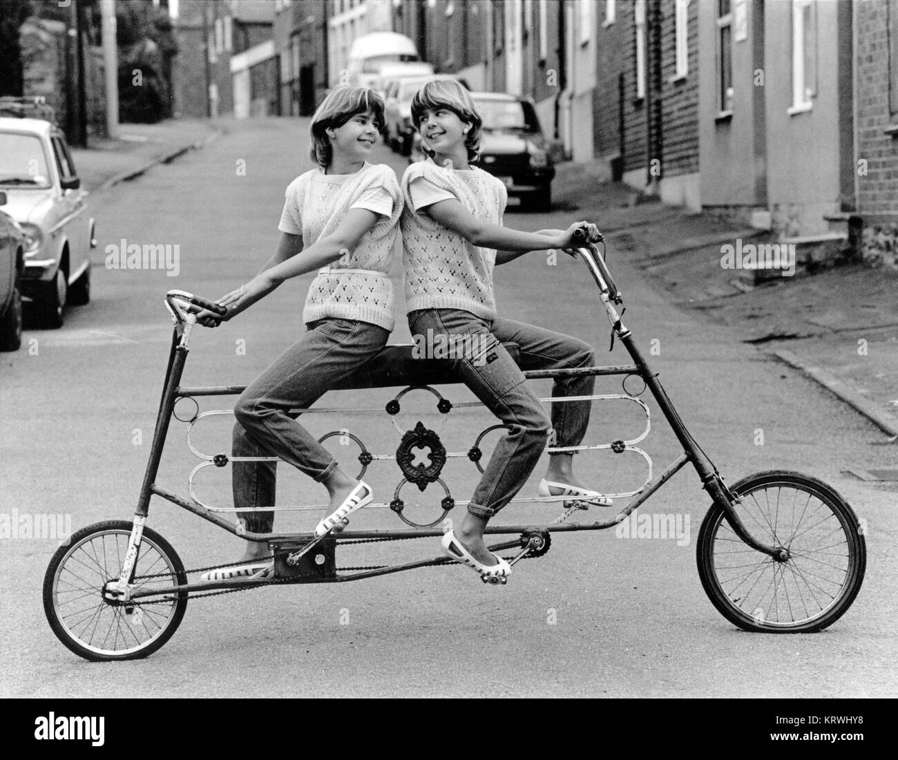 Twins on a curious bicycle, England, Great Britain Stock Photo