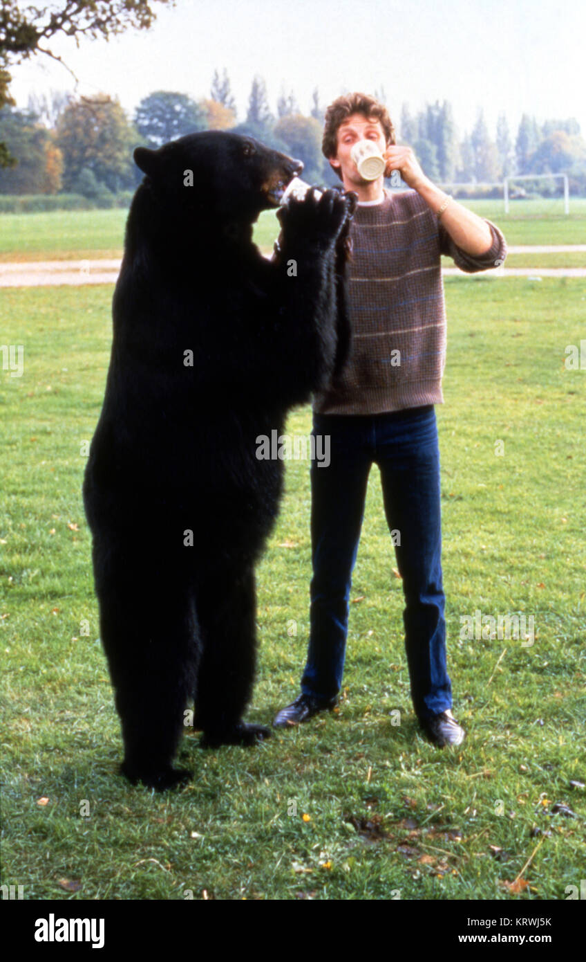 Grizzly Bear Standing Next To Man
