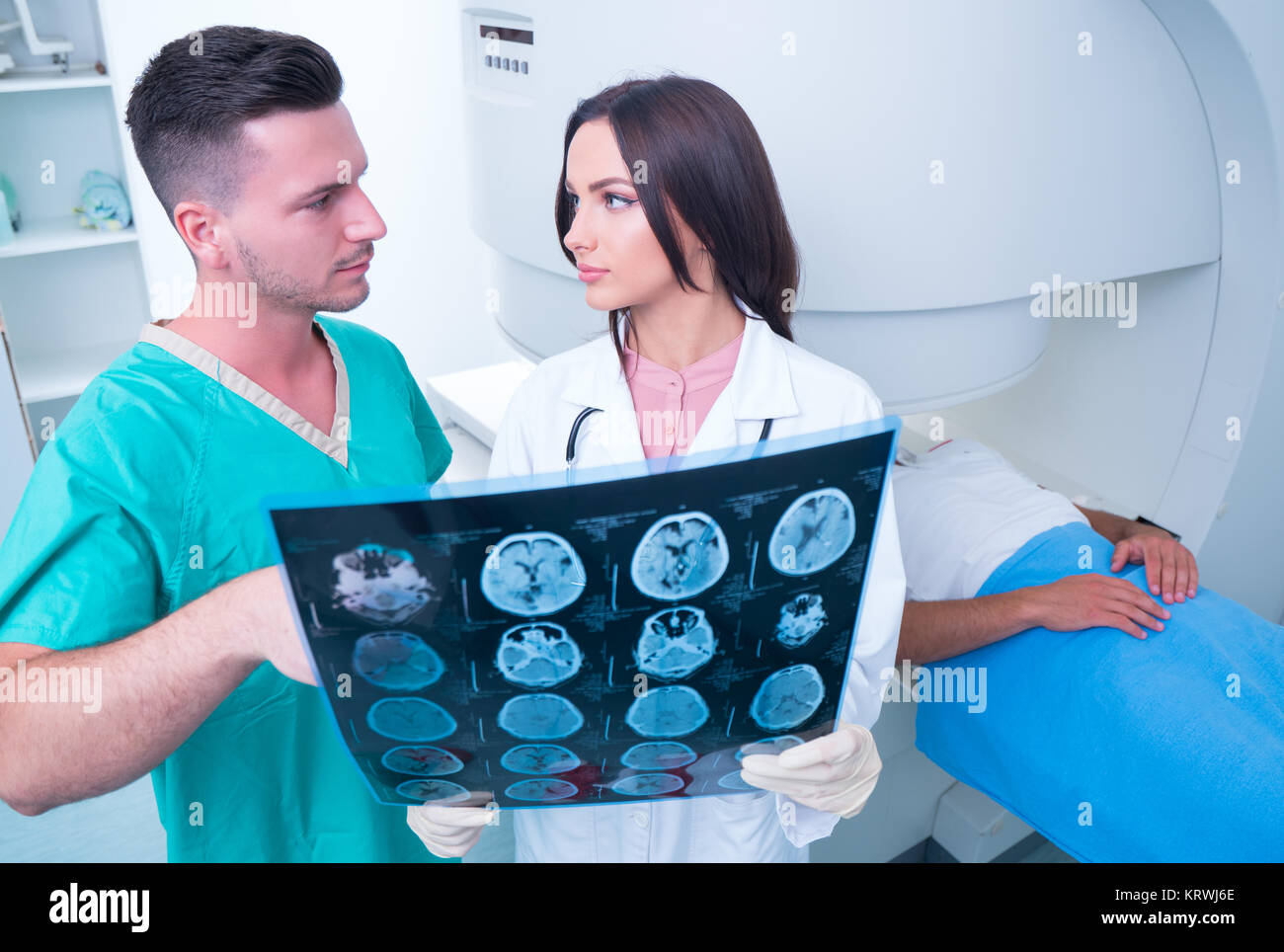 Confident pleasant doctor working with MRI scan results Stock Photo - Alamy