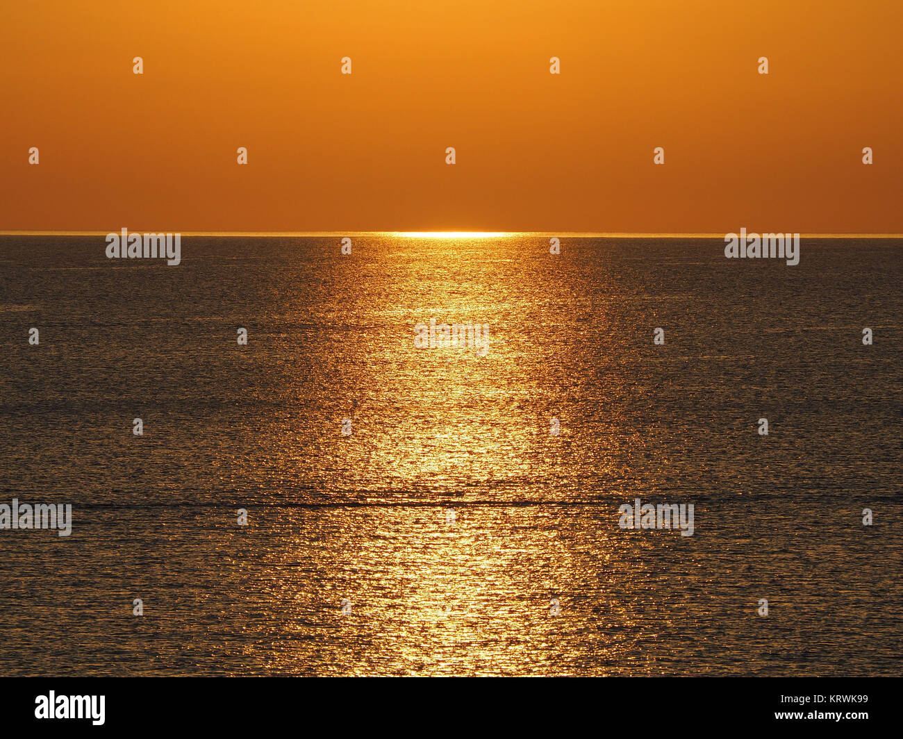 Golden light reflections at sunset in the sea, Corsica, France Stock Photo